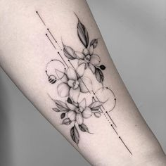 a black and white flower tattoo on the arm