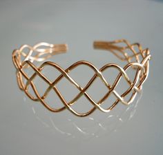 "This four strand braided will turn heads at that special event. It is a perfect transitional piece that works at settings from dressy to every day. It makes a great gift or addition to your own collection. I make the bracelet by hand braiding 14K gold filled wire. As such each bracelet is unique. The bracelet is a cuff shape in 16 gauge wire so it holds its shape well. Bracelets come in three sizes: Small, Medium and Large. Just specify your size at checkout. If unsure of size, tell me your wri Elegant Bracelets With Interwoven Design As Gift, Elegant Bracelets With Interwoven Design For Gift, Formal Adjustable Braided Bracelets, Formal Adjustable Braided Bracelet, Elegant Adjustable Braided Jewelry, Adjustable Interwoven Bracelets As Gift, Four Strand Braids, Braid Bracelet, Strand Braid