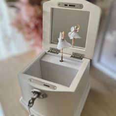 a small white box with an angel figurine in it