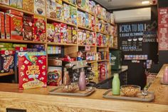 the cereal bar is stocked with cereal, milk, and other foodstuffs for sale