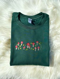 a green t - shirt with mushrooms on it