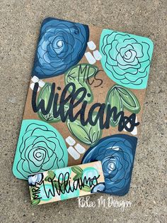 a piece of cardboard with the words welcome on it and blue flowers painted on it