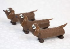 three chocolate dachshunds with googly eyes on them