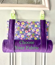 a purple purse hanging on a door with the words choose your fabric written in green