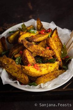 a white plate topped with fried plantains and chopsticks