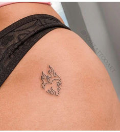 the back of a woman's shoulder with a small tattoo on her left side