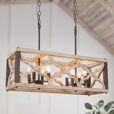 a wooden chandelier with candles hanging from it's center beam in a room