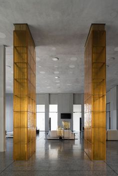 an empty room with gold columns and chairs