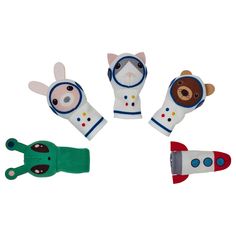 four small stuffed animals are arranged in the shape of an airplane, bear, and alligator