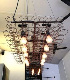 a chandelier hanging from the ceiling in a room with many lights on it