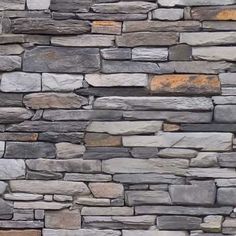 a stone wall with different colors and shapes