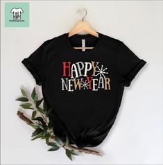 Happy New Year Shirt, New Year 2025 Shirt, New Year Gift, Hello 2025 Tshirt, New Years Eve Shirt, Family New Year Tee, 2025 Party Shirt Welcome to my shop, I am a professional designer and craft my own shirts. I started this journey from scratch and have gained lots of experience. I can craft custom shirts with custom designs. Our handmade, specially designed shirts will be the perfect choice for your celebrations, vacations, graduations or birthday & wedding parties and holidays.  Discount avai New Year Theme Shirts, Hello 2025, New Year Gift Crew Neck T-shirt, New Years Shirts 2022, Holiday New Year Cotton T-shirt, Happy New Year Shirt, New Years Eve Shirt, New Year Shirt, Designed Shirts