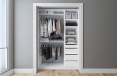 an open white closet with clothes hanging on the doors and shelves in front of it