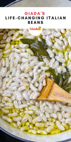 a pot filled with white beans and spinach next to a wooden spoon in it