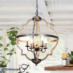 a chandelier hanging from the ceiling in a kitchen