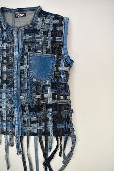 a piece of clothing made out of old jeans with holes and frays on it