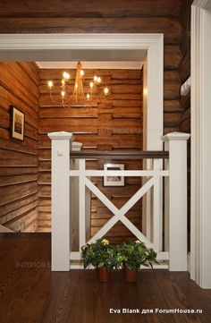 a room with wooden walls and white railings