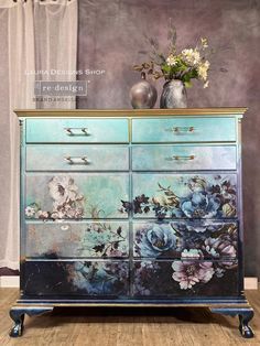 an old dresser with flowers painted on it