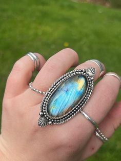 Measurements: 5.5cm X 2.5cm Weight: .81oz  Size: 8.25 (fits like an 8)  Stone: Labradorite  Ring Band: 10 gauge half round stacked triple shank.  Thank you for choosing High Peak Silver for your jewelry needs. I hope you allow my wearable art to bring a smile to your face day after day, year after year. Let them dazzle you and add some flare to everyday looks. Here are some commonly asked questions and policies. High Peak Silver is a one women operation. I do everything from the ordering/designing/creating/photography/pricing/website/customer service/social media/shipping and everything in-between. Proper care: Sterling silver is sensitive, in order to best care for you sterling silver, make sure to take it off before swimming in chlorine or salt water, avoid contact with perfumes and loti Oval Labradorite Cabochon Jewelry, Oval Cabochon Labradorite Jewelry, Handmade Oval Labradorite Jewelry, Unique Oval Labradorite Jewelry, Unique Oval Moonstone Ring With Natural Inclusions, Vintage Oval Labradorite Jewelry, Handcrafted Oval Moonstone Ring, Handmade Artisan Oval Moonstone Ring, Unique Untreated Oval Moonstone Ring