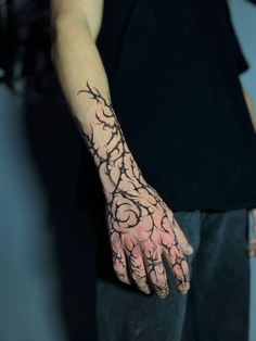 a man's hand with black ink on it and flowers all over the palm