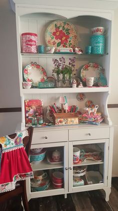 a china cabinet with plates and bowls on it