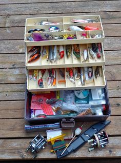 an open suitcase filled with lots of different types of fishing lures