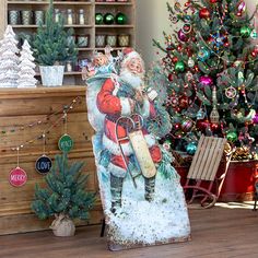 a christmas scene with a santa clause standing in front of a tree