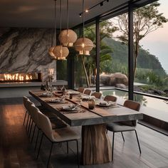 a dining room table set with plates and place settings in front of an outdoor fireplace