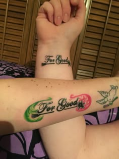 two people with tattoos on their arms and one has the words for good written on it