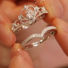 two wedding rings that have been made to look like princess crowns