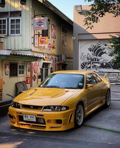 a yellow car parked in front of a building