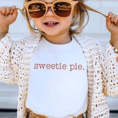 Sweetie Pie Thanksgiving Toddler Tee, Kids Shirt or Baby Onesie®.  Little Peekoos™ is the place to find trendy, cute and funny baby bodysuits, kid's t-shirts and raglan tees for your baby, toddler, or young child which are perfect for photographs, family trips or your holiday celebration. Our goal is to provide Cute Kids Clothes with Fun Expressive Designs for all occasions. Our trendy and custom designs are professionally printed in house and ships either same day or next business day.  We take great care to provide only the best for your little ones, therefore we only use CPSIA Compliant, 100% cotton and/or organic garments, inks & materials.  *We also print our natural onesies® and natural toddler shirts on Gerber's new premium line of garments. For more information on CPSIA children sa Thanksgiving Shirts For Kids, Toddler Thanksgiving Shirt, Sweeter Than Pumpkin Pie, Minimalist Thanksgiving, Pumpkin Pie Thanksgiving, Thanksgiving Toddler, Pie Thanksgiving, Thanksgiving Baby