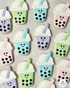 iced cookies decorated with pastel colors and black polka dots are arranged in the shape of cocktails