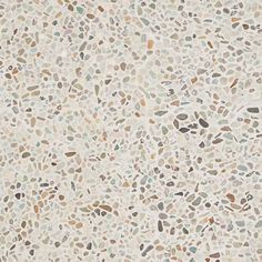 a white and brown tile wallpaper with different colored spots on it's surface