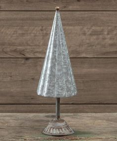 a small metal christmas tree on top of a wooden table