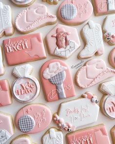 pink and white decorated cookies are arranged on a table with the names of each cookie