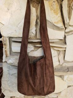 "This beautiful dark brown suede bag is lined in your choice of fabric. Cell phone pocket on the inside. Crossbody. Can be ordered as a knotted top shoulder bag. Add a note in the message spot you'd like the knotted top. Top stitched for extra durability. Holds a huge amount of stuff. Super comfortable to wear. Wear as an everyday bag, a day trip bag, travel bag, book bag etc... This bag is machine washable. Cold water, line dry. This is a man made product. 100% polyester suede product. It is a Hobo Sling Bag, Brown Sling Bag, Trip Bag, Black Rucksack, Slouch Bag, Knotted Top, Slouch Bags, Suede Purse, Denim Handbags