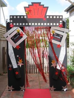 a red carpet is on the ground in front of a black and white structure with stars