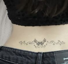 a woman with a butterfly tattoo on her stomach