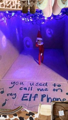 an elf is sitting in the middle of a room with shoes on it and a sign that says, you used to call me on my iphone