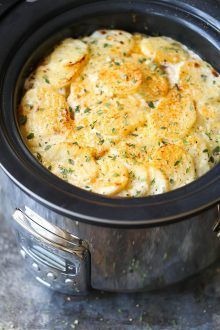 a crock pot filled with food sitting on top of a stove