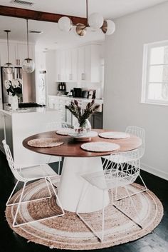 a kitchen table with chairs around it