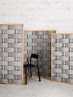 a chair sitting in front of a wall made out of blocks