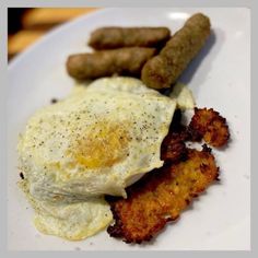 an egg and sausage breakfast on a white plate