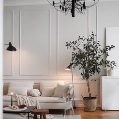 a living room filled with furniture and a white refrigerator