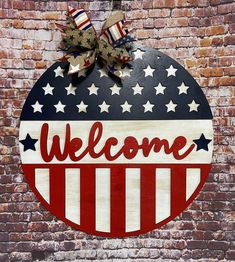 a welcome sign on the side of a building with stars and stripes painted on it