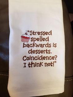 a hand embroidered dish towel that says,'stressed spelled backwardss is desserts condence i think not '