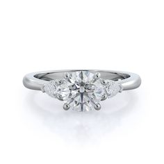 a three stone diamond ring on a white background