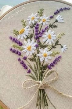 a close up of a cross stitch with flowers on it