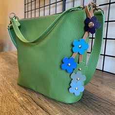 Size: Total Length: About 10"(25.5cm) Top part Length: About 5"(12.5 cm) Can be attached to the bag handle diameter up to 1.25” (3 cm) Diameter of flowers: About 1.5”(3.8cm) Material: Leather (North American Cowhide /Glove Leather) Pattern/Color: Color A |Green, Orange, Blue, Yellow, Khaki, RedColor B | Red, Pink, WhiteColor C | Purple, Green, Blue, GrayColor D | Black, Orange, Brown, Light Yellow, Yellow, Green Care Instruction: Apply a cleaner especially made for leather. Moisturize your walle Green Floral Shoulder Bag For Everyday Use, Green Flower Shaped Shoulder Bag For Daily Use, Green Flower-shaped Shoulder Bag For Daily Use, Green Floral Shoulder Bag For Daily Use, Green Flower-shaped Everyday Bags, Toe Socks For Women, Spa Gift Card, Flowers Easy, Merino Wool Socks